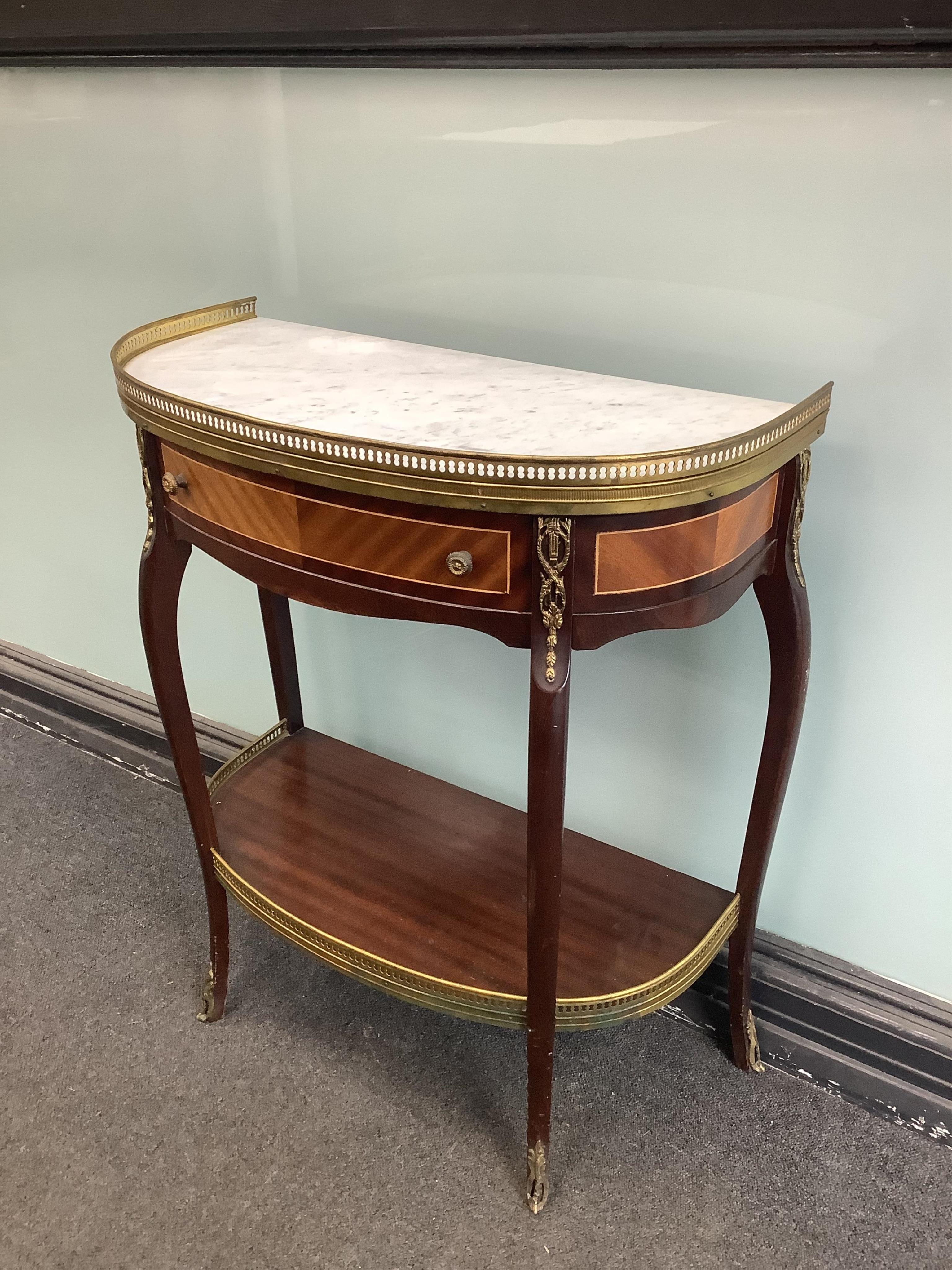 A Louis XVI style gilt metal mounted mahogany two tier marble top side table, width 62cm, depth 31cm, height 73cm. Condition- good